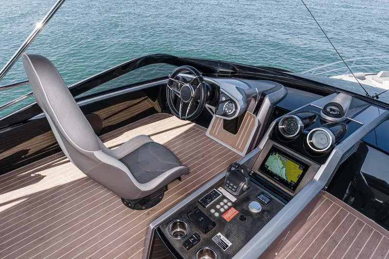 Slide: The Image of Cockpit of 2023 Sunseeker 65 Sport Yacht with modern navigation controls. - 18