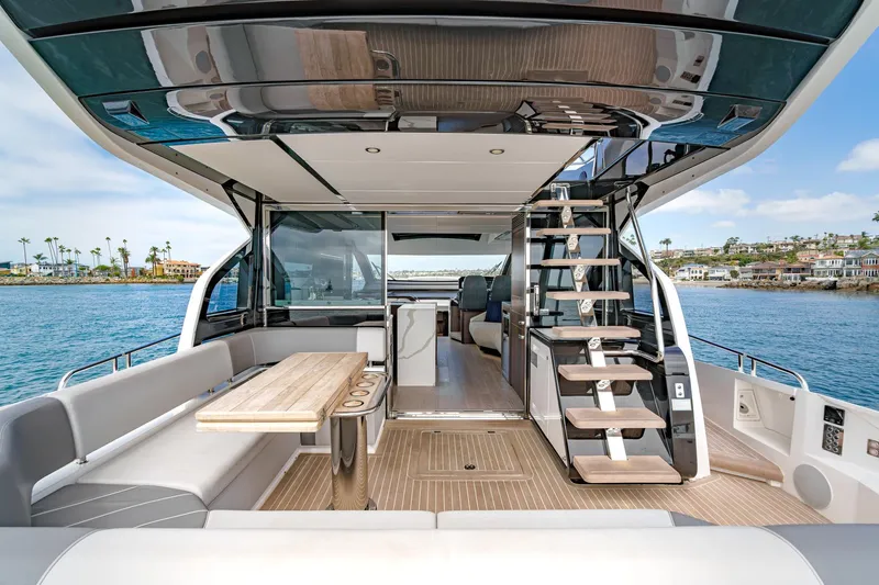 Slide: The Image of 2023 Sunseeker 65 Sport Yacht interior with modern seating and ocean view. - 20