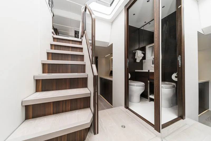 Slide: The Image of Luxurious interior of 2023 Sunseeker 65 Sport Yacht featuring elegant staircase and modern bathroom. - 48