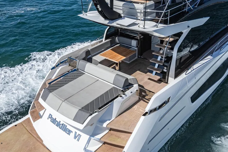 Slide: The Image of 2023 Sunseeker 65 Sport Yacht cruising on open water, featuring luxurious deck and seating area. - 5