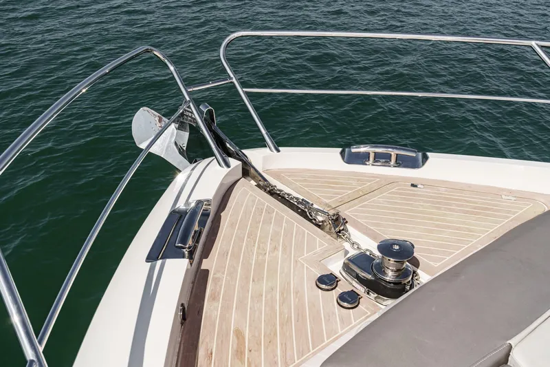 Slide: The Image of Bow of 2023 Sunseeker 65 Sport Yacht with anchor and teak decking. - 60