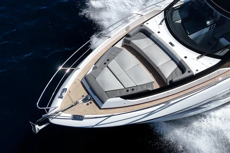 Slide: The Image of 2023 Sunseeker 65 Sport Yacht cruising on open water, showcasing sleek design and luxury seating. - 7