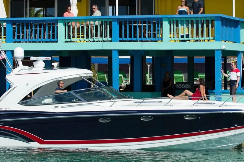 Slide: The Image of 2017 Formula 400 Super Sport boat cruising near a vibrant waterfront building. - 2