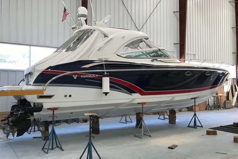 Slide: The Image of 2017 Formula 400 Super Sport boat in a storage facility, elevated on stands. - 3
