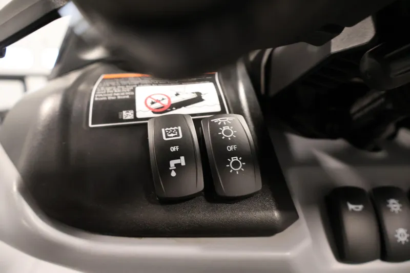 Slide: The Image of Control switches on 2025 Sea-Doo Switch Fish 21 dashboard, featuring light and water functions. - 25