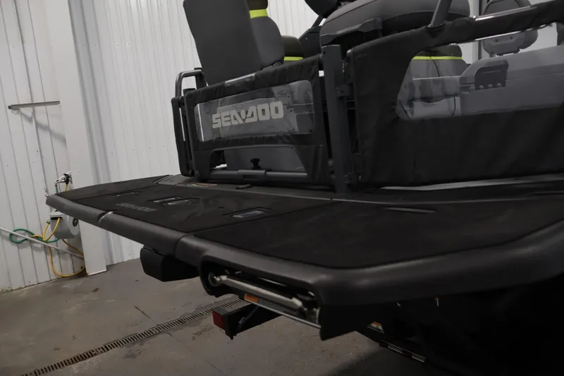 Slide: The Image of 2025 Sea-Doo Switch Fish 21 rear view in a garage setting. - 35