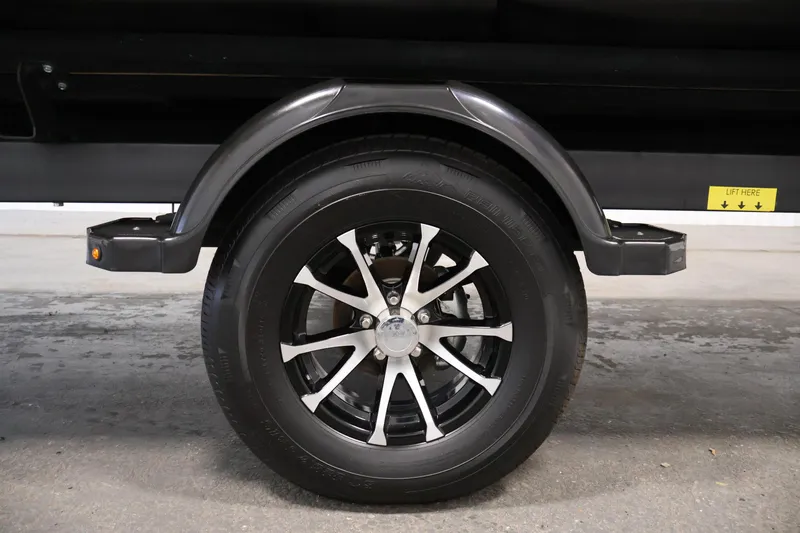 Slide: The Image of Trailer wheel of 2025 Sea-Doo Switch Fish 21, featuring sleek black and silver design. - 40