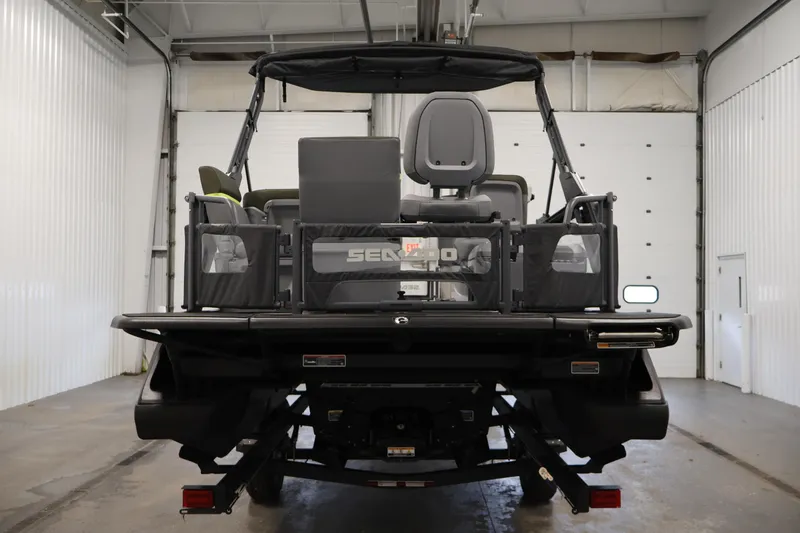 Slide: The Image of Rear view of 2025 Sea-Doo Switch Fish 21 in a garage. - 6