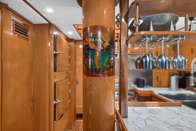 Slide: The Image of Interior of 1961 Vic Franck Custom yacht with wood paneling and modern kitchen amenities. - 13