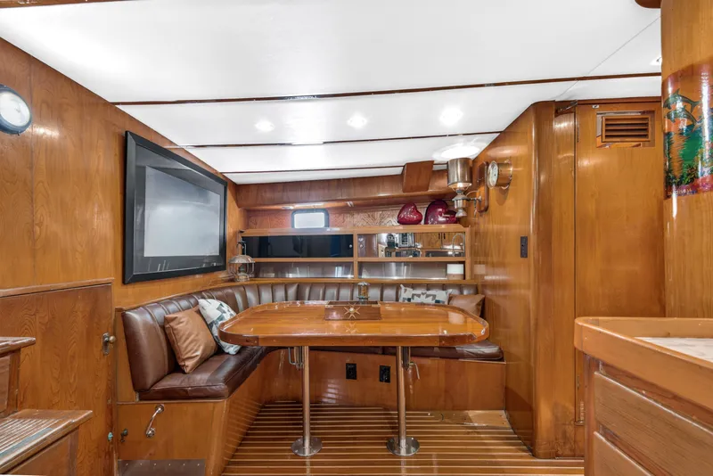 Slide: The Image of Luxurious 1961 Vic Franck Custom yacht interior with wood paneling and cozy seating area. - 14