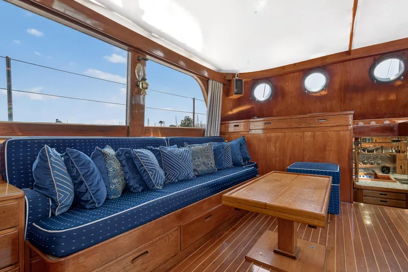 Slide: The Image of Luxurious 1961 Vic Franck Custom yacht interior with blue cushions and wooden accents. - 15