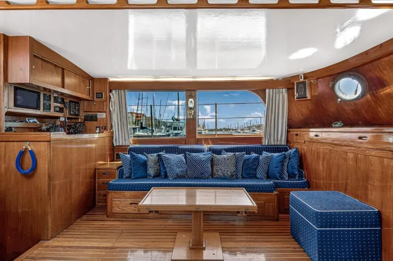 Slide: The Image of Luxurious 1961 Vic Franck Custom yacht interior with wooden finishes and blue seating. - 16