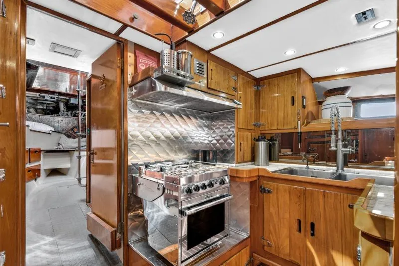Slide: The Image of 1961 Vic Franck Custom yacht kitchen with wood cabinetry and stainless steel appliances. - 18