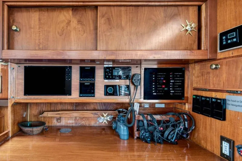 Slide: The Image of 1961 Vic Franck Custom yacht navigation panel with wooden cabinetry and modern equipment. - 19