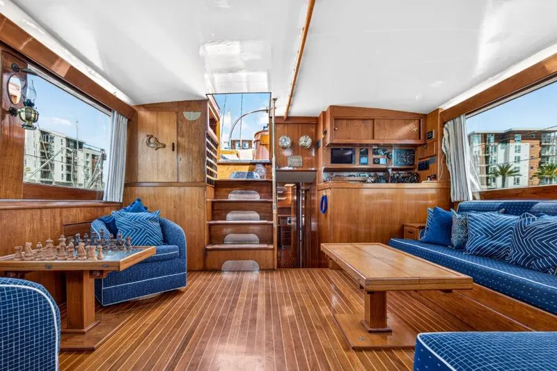 Slide: The Image of Luxurious 1961 Vic Franck Custom yacht interior with wood paneling and blue seating. - 2