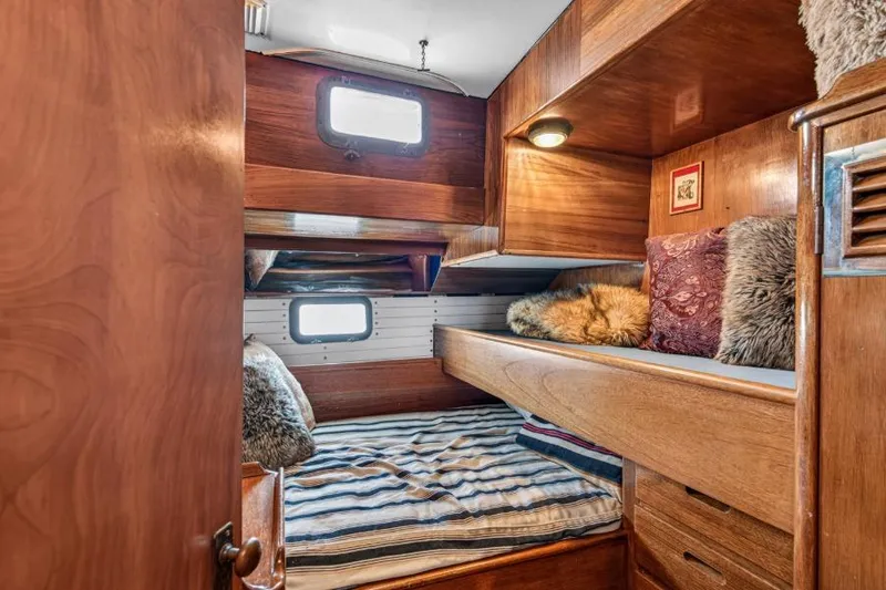 Slide: The Image of Cozy wooden cabin interior of 1961 Vic Franck Custom boat with bunk beds and pillows. - 22