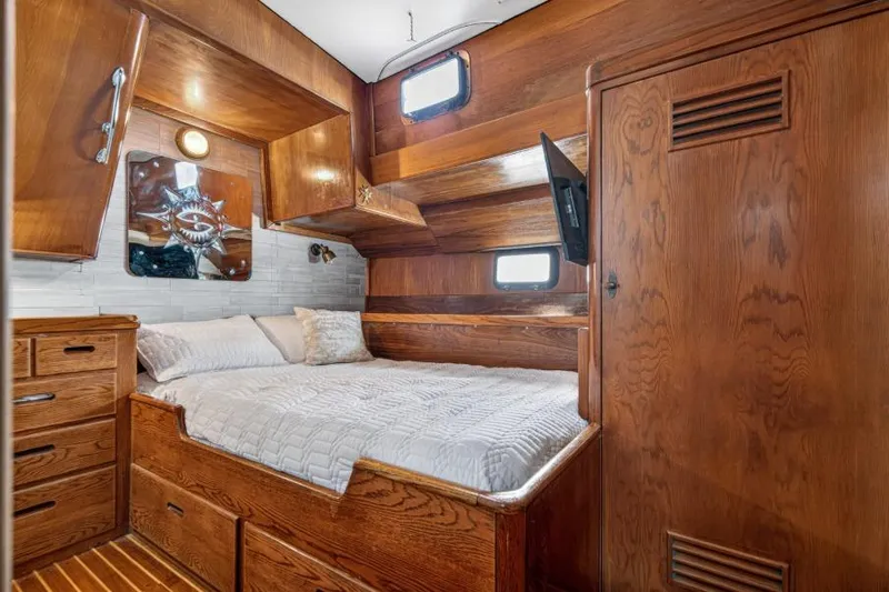 Slide: The Image of Cozy wooden cabin interior of 1961 Vic Franck Custom boat with bed and storage. - 23