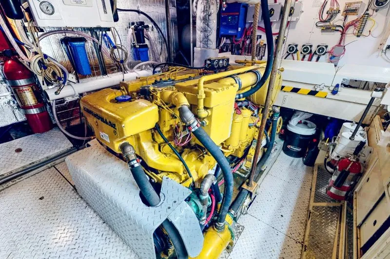 Slide: The Image of Engine room of a 1961 Vic Franck Custom boat with yellow machinery and equipment. - 31