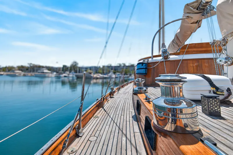Slide: The Image of 1961 Vic Franck Custom yacht deck with polished wood and chrome details, docked in a serene marina. - 4