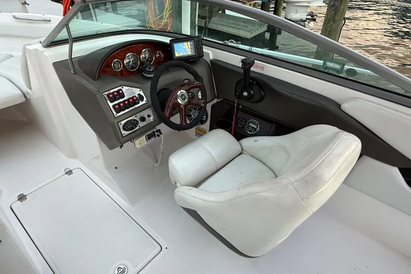 Slide: The Image of 2004 Regal 2000 Bowrider boat cockpit with steering wheel and control panel. - 20