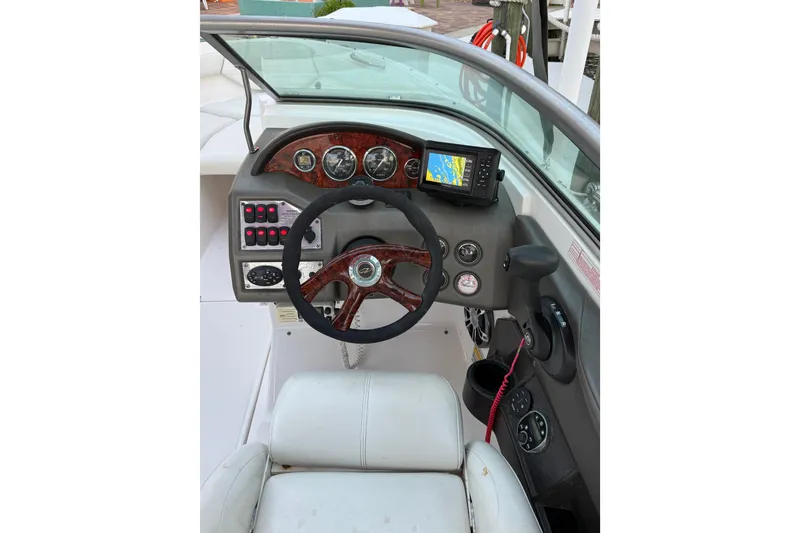 Slide: The Image of 2004 Regal 2000 Bowrider dashboard with steering wheel, gauges, and navigation system. - 21