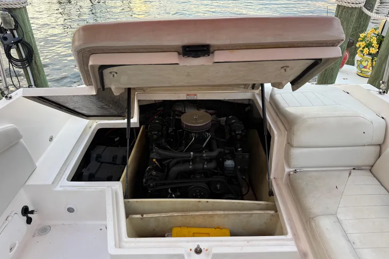 Slide: The Image of 2004 Regal 2000 Bowrider boat engine compartment with open hatch, dockside view. - 27