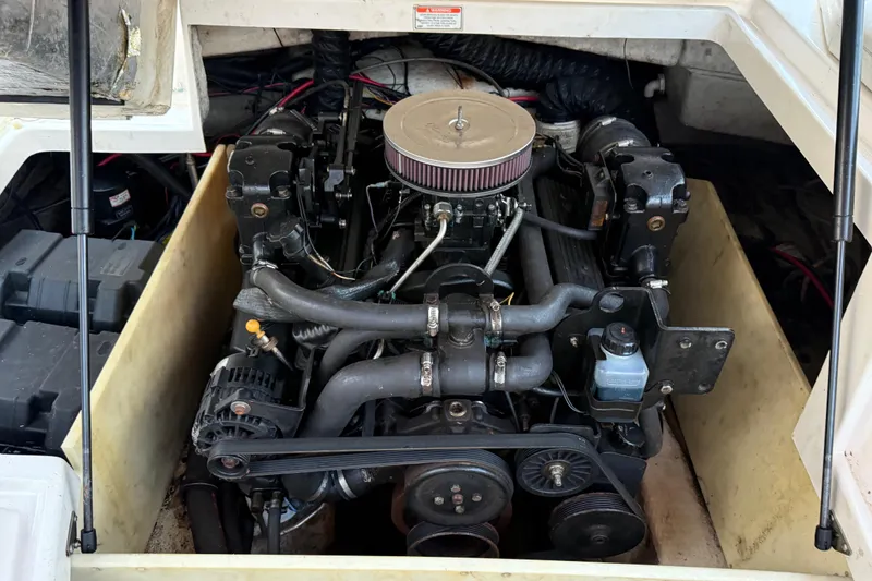 Slide: The Image of Engine compartment of a 2004 Regal 2000 Bowrider boat, showcasing detailed mechanical components. - 28