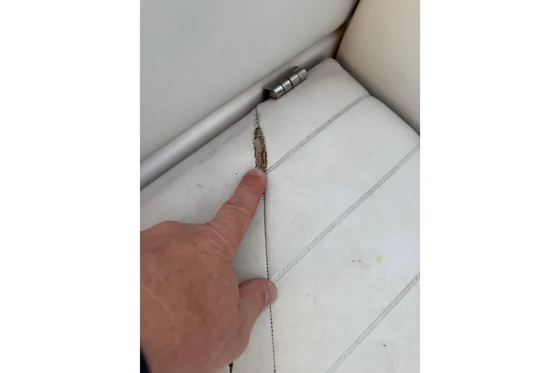 Slide: The Image of Close-up of a damaged seat seam on a 2004 Regal 2000 Bowrider boat. - 30