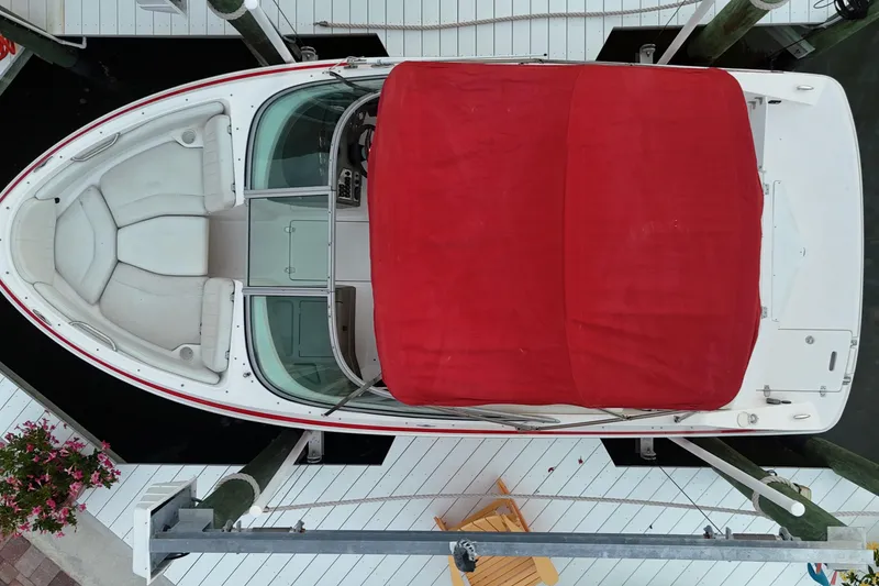Slide: The Image of 2004 Regal 2000 Bowrider with red cover docked at marina, aerial view. - 7