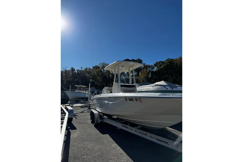 The Image of 2020 Boston Whaler 240 Dauntless boat on trailer under clear blue sky. - 0