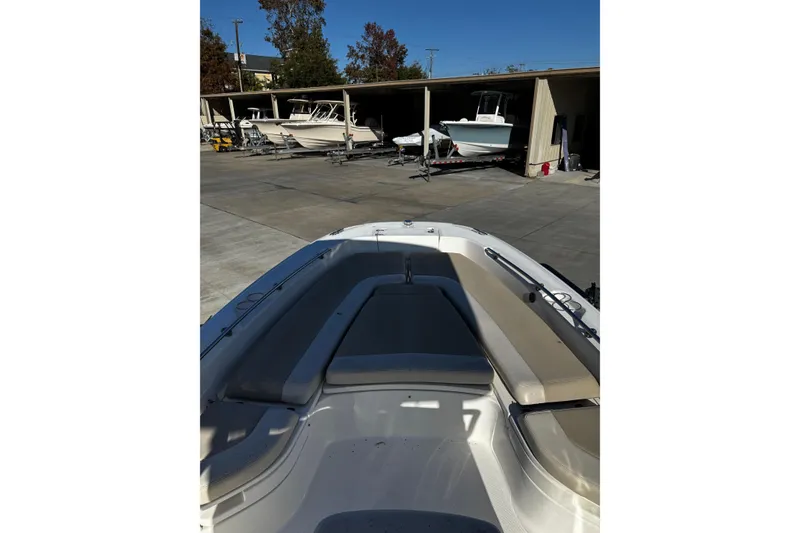 Slide: The Image of 2020 Boston Whaler 240 Dauntless boat in storage facility, showcasing bow seating area. - 2