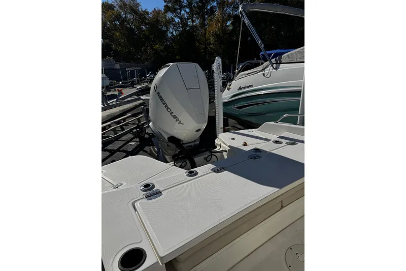 Slide: The Image of 2020 Boston Whaler 240 Dauntless boat with Mercury engine, docked outdoors. - 3
