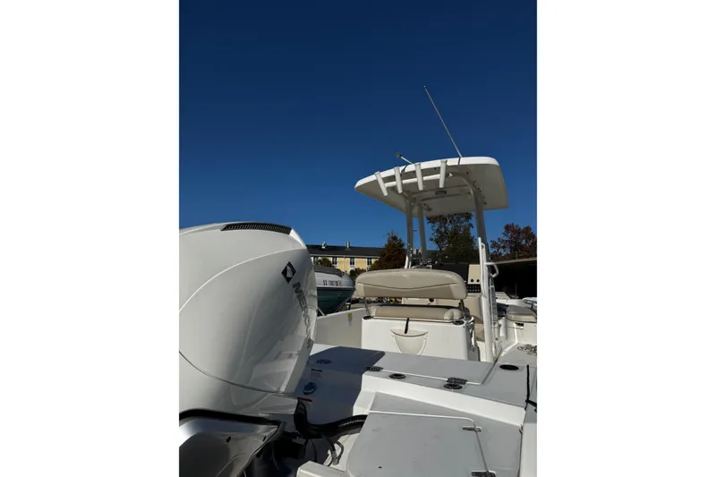 Slide: The Image of 2020 Boston Whaler 240 Dauntless boat with Mercury engine, under clear blue sky. - 4