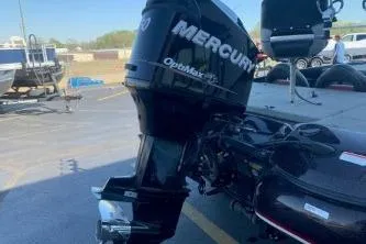 Slide: The Image of 2010 Nitro Z-7 boat with Mercury OptiMax engine in a parking lot. - 7