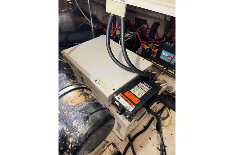 Slide: The Image of Engine compartment of 2002 Cruisers Yachts 3575 Express with visible wiring and components. - 12