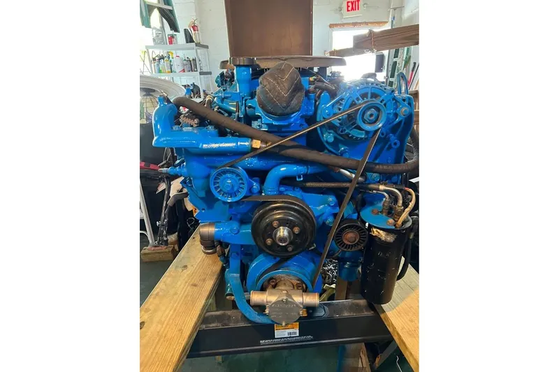 Slide: The Image of Blue marine engine of a 2002 Cruisers Yachts 3575 Express in a workshop setting. - 13