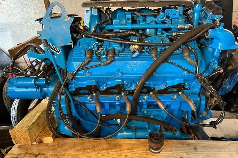 Slide: The Image of Blue engine of a 2002 Cruisers Yachts 3575 Express, displayed on wooden blocks. - 14