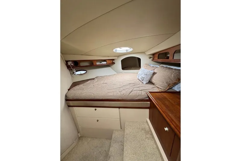 Slide: The Image of Interior cabin of 2002 Cruisers Yachts 3575 Express with cozy bed and wooden accents. - 18