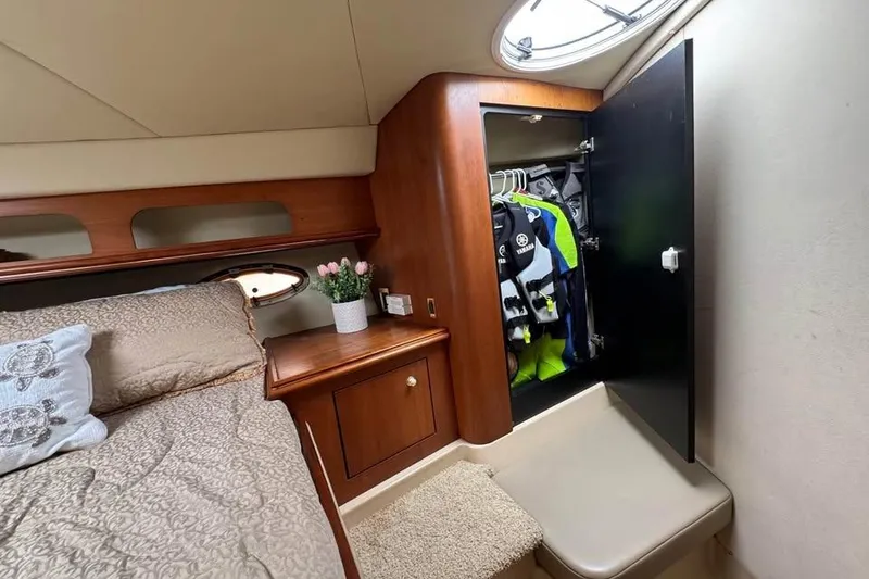 Slide: The Image of Cozy cabin interior of 2002 Cruisers Yachts 3575 Express with bed, closet, and decor. - 19