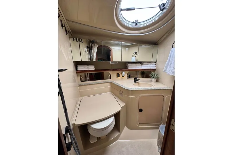 Slide: The Image of Luxurious bathroom in 2002 Cruisers Yachts 3575 Express, featuring modern fixtures and ample storage. - 20
