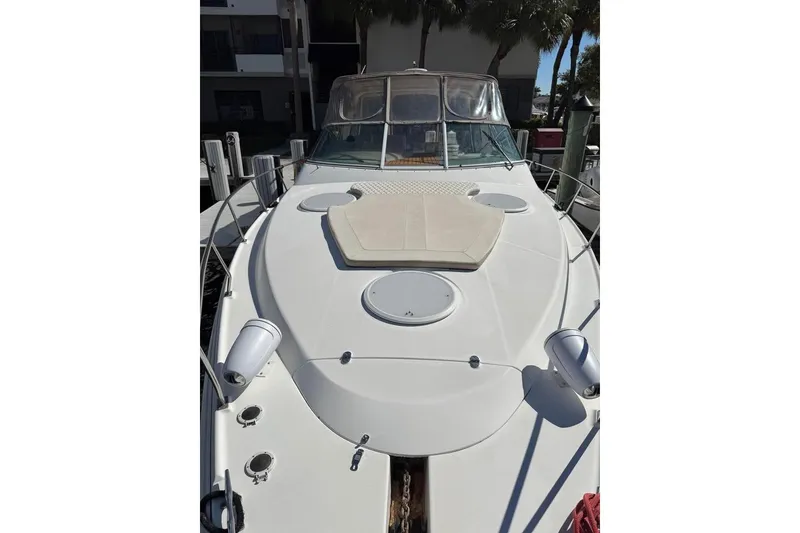 Slide: The Image of 2002 Cruisers Yachts 3575 Express boat docked, showcasing spacious deck and sleek design. - 4