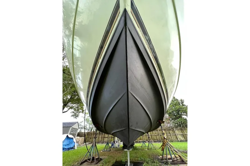 Slide: The Image of 2002 Cruisers Yachts 3575 Express boat hull on stands, viewed from below. - 5