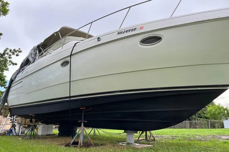 Slide: The Image of 2002 Cruisers Yachts 3575 Express on stands, side view, outdoors. - 6