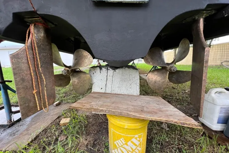 Slide: The Image of 2002 Cruisers Yachts 3575 Express propellers and rudders on dry land. - 7