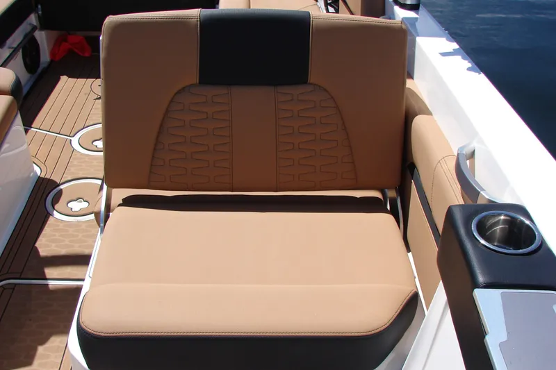 Slide: The Image of 2021 MasterCraft X26 boat seat with tan upholstery and cup holder. - 10