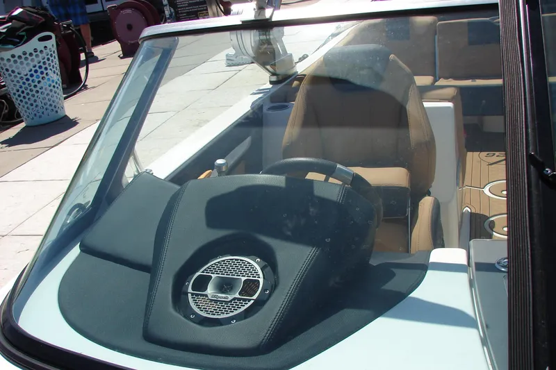 Slide: The Image of Interior view of 2021 MasterCraft X26 boat, featuring steering wheel and seating. - 11