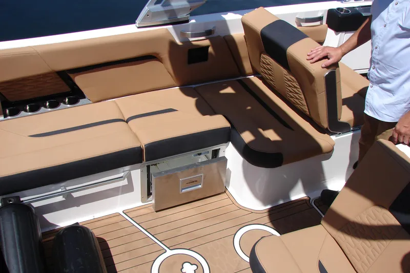 Slide: The Image of 2021 MasterCraft X26 boat interior with tan leather seating and teak flooring. - 18