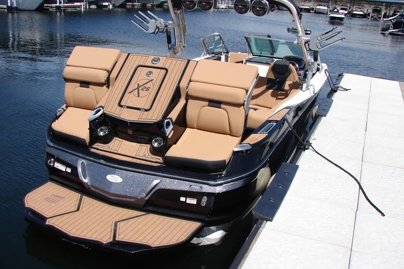 Slide: The Image of 2021 MasterCraft X26 boat docked, featuring luxurious seating and sleek design. - 19