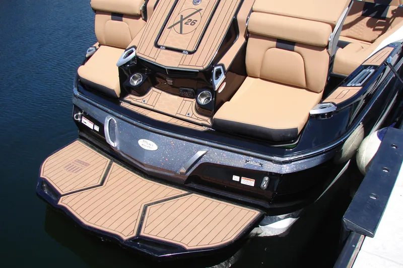 Slide: The Image of 2021 MasterCraft X26 boat with tan seating and sleek design on the water. - 20
