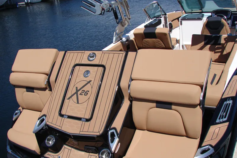 Slide: The Image of 2021 MasterCraft X26 boat with luxurious tan seating and sleek design on the water. - 21